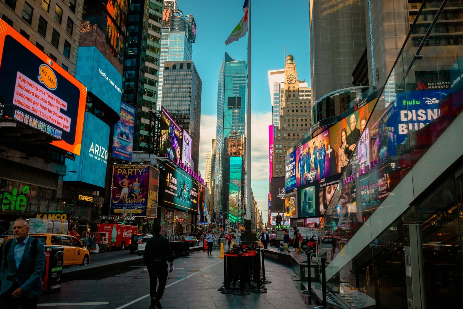 A view of Times Square in New York City, USA, including signs for various shows and attractions.
